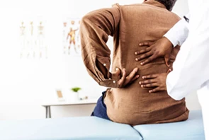 Chiropractic San Antonio, TX Man With Back Pain Explaining