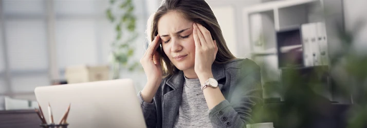Chiropractic San Antonio, TX Woman at Computer with Headache