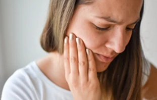 Chiropractic San Antonio, TX Woman in TMJ Pain