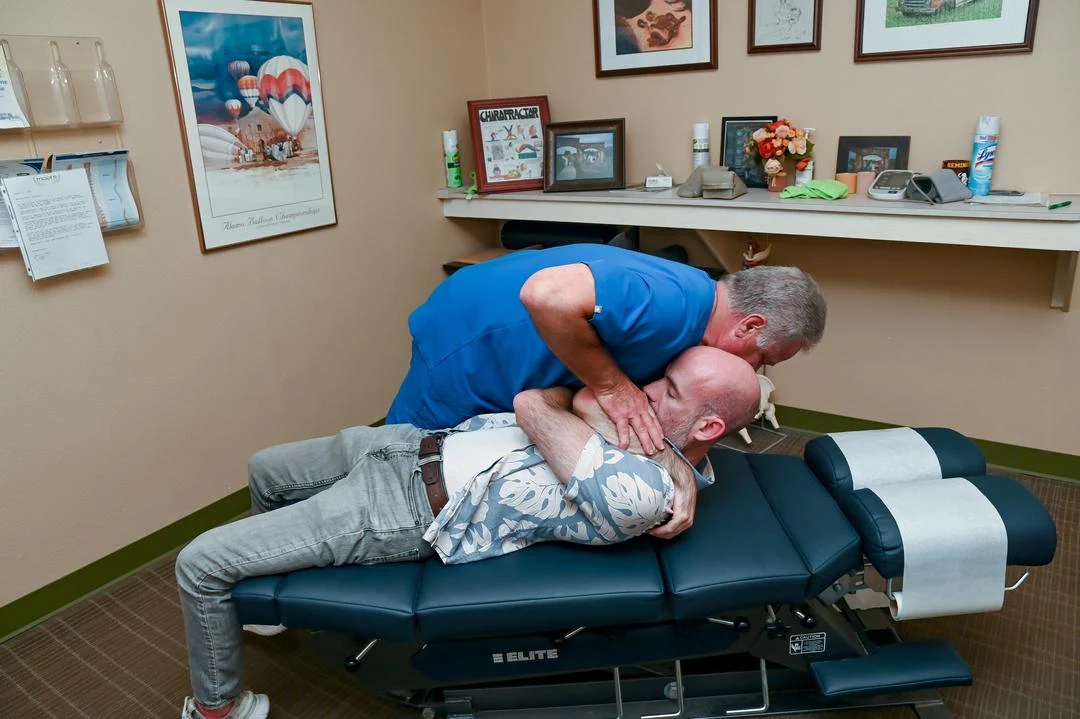 Patient with back discomfort receiving care at Moore Chiropractic